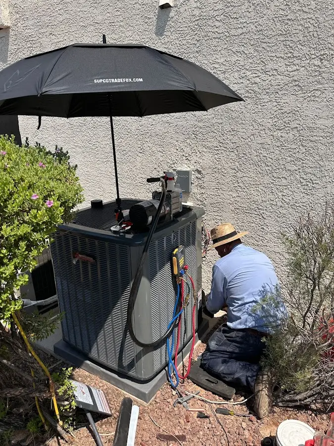 HVAC technician performing outdoor AC maintenance in Johns Creek